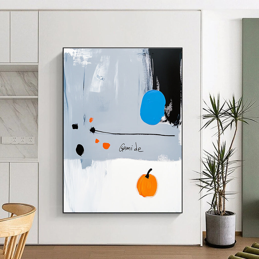 Abstract painting of a right-pointing arrow in blue white gray orange and black with Gamide text and a cartoonish pumpkin on light gray background.STSC1073