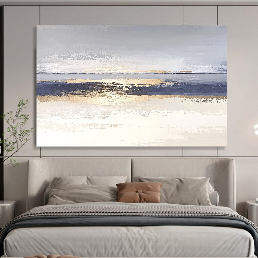 Large abstract painting with soft light blue and gray tones featuring metallic gold lines depicting water ripples on serene sand.SC007