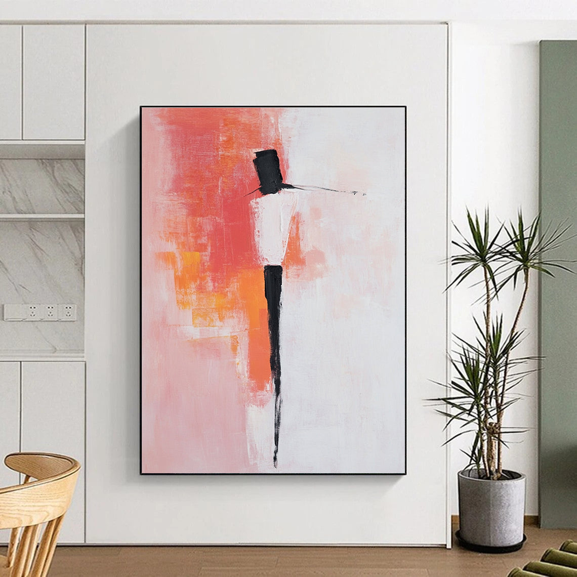 Large abstract painting with pink and white background featuring bold brush strokes simple shapes and peachy red accents with black dress shoes.STSC404