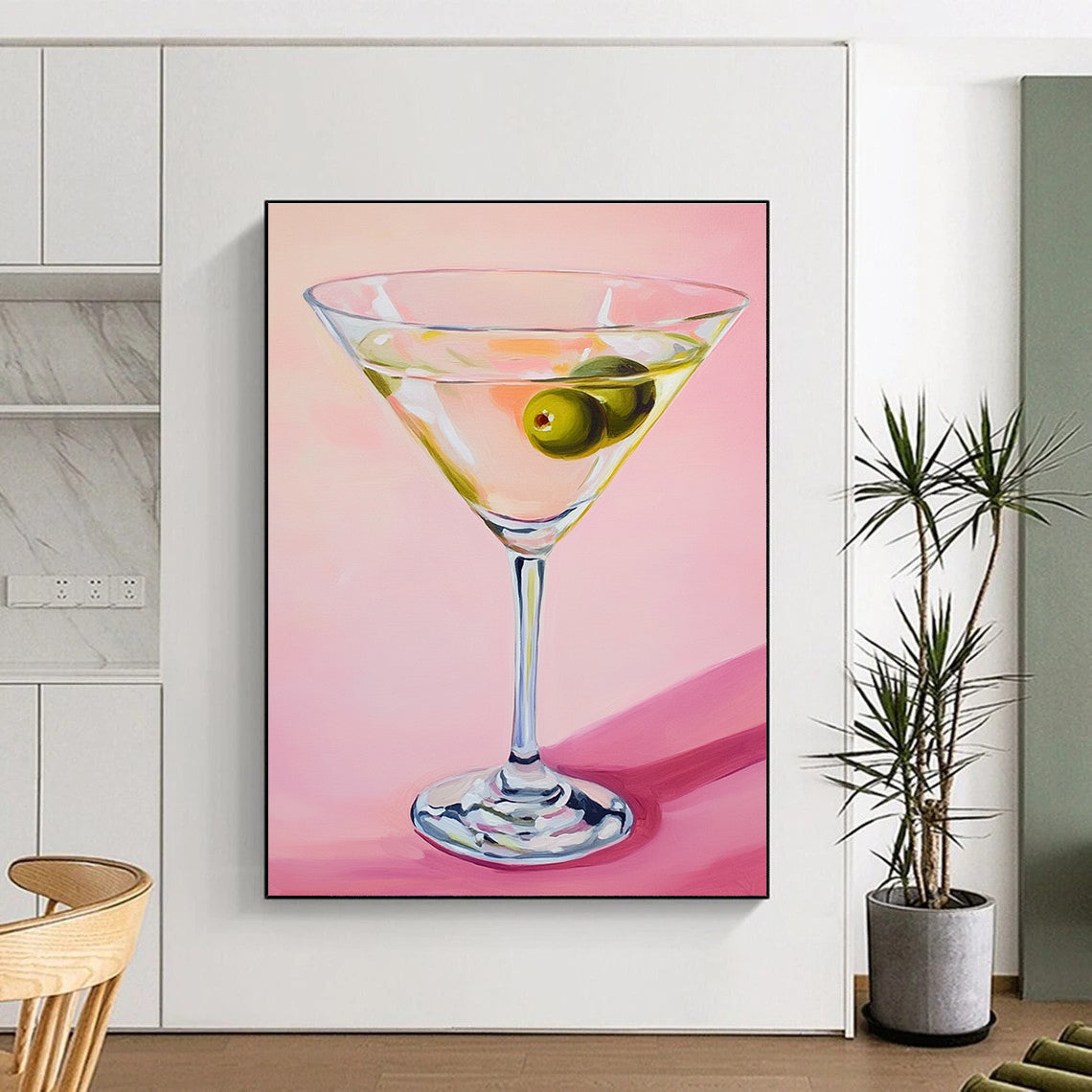 Abstract painting featuring a martini glass with an olive against a soft pink background showcasing gentle lighting and serene elegance.STSC1383