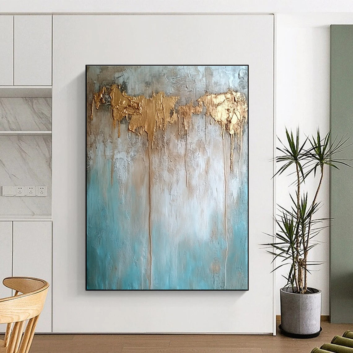 Large abstract painting with texture in neutral tones featuring light blue brown and gold hues highlighting water damage elements against a concrete wood background.STSC136
