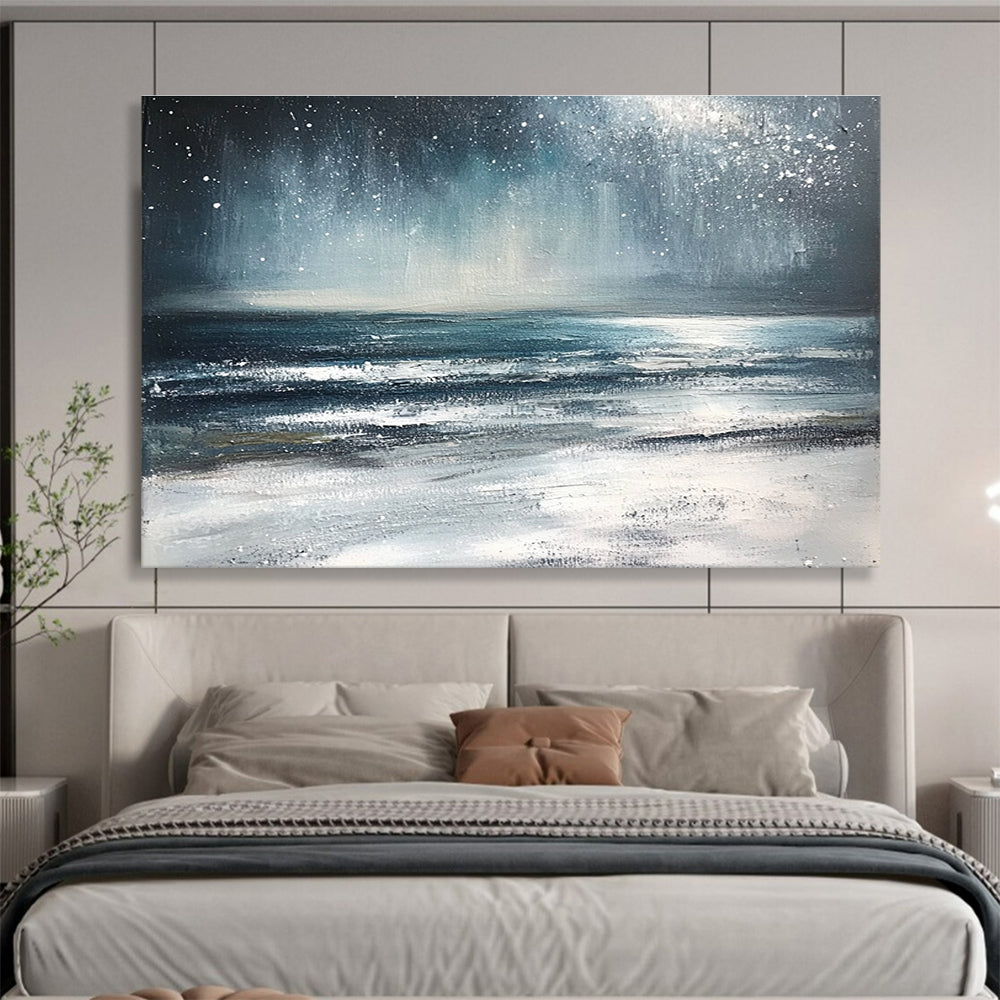 Large abstract painting depicting a winter ocean scene with dark blue and gray tones a starry white sky and sandy beach resembling snow.SC412
