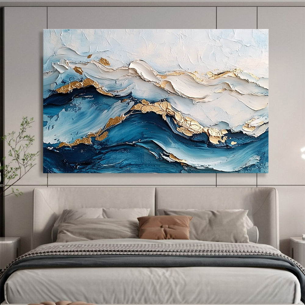 Large abstract painting featuring ocean waves in textured white and blue hues with gold accents for depth and elegance.SC102