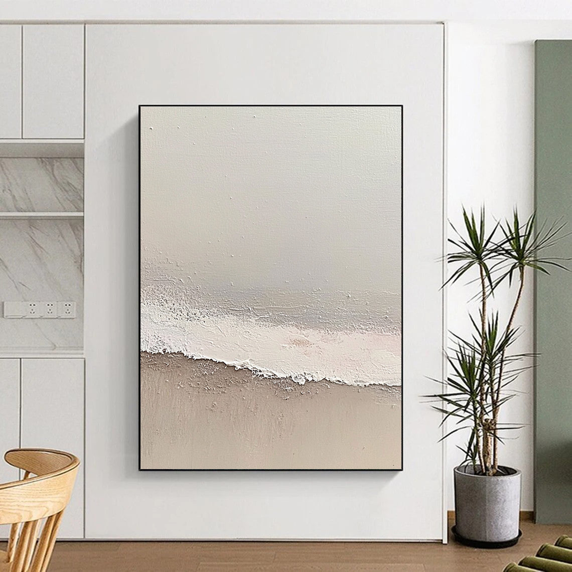 Large abstract painting depicting a serene beach scene with soft gray and pale pink tones featuring gentle waves and textured surfaces.STSC1427