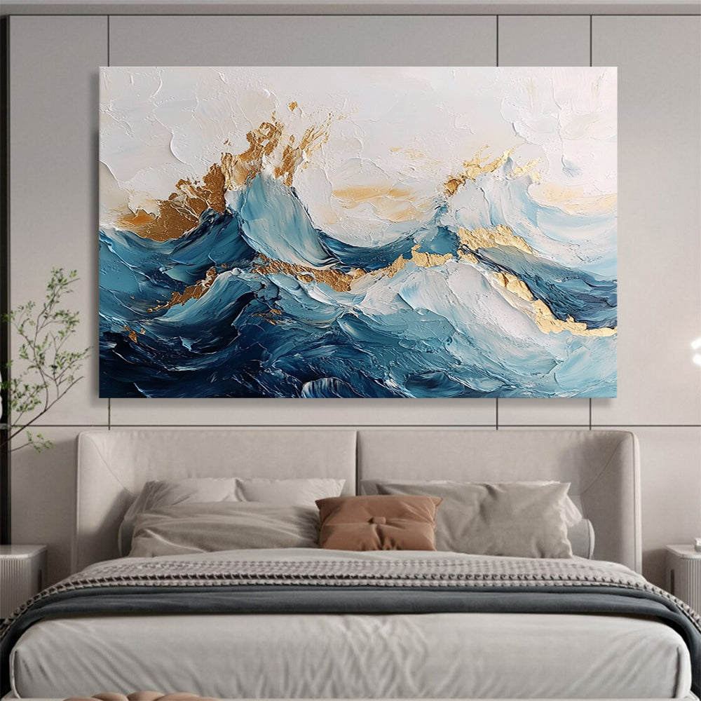 Large abstract painting of ocean waves in blue and white with gold accents featuring textured brush strokes and fluid shapes that convey movement.SC101