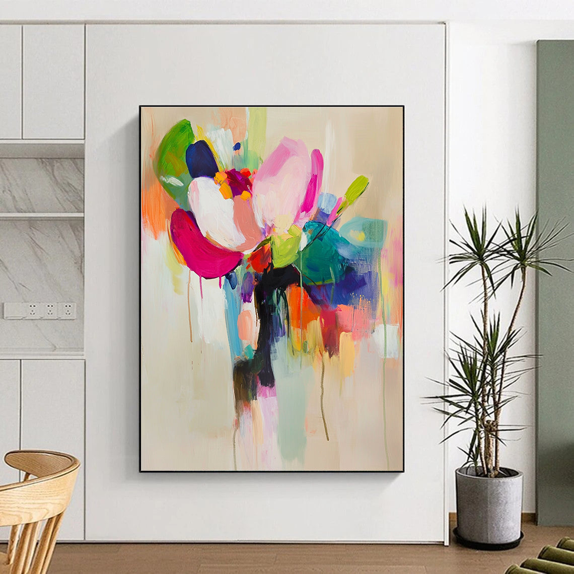 Large abstract painting featuring vibrant colors and soft brushstrokes with a flower in a vase on a light beige background.STSC822
