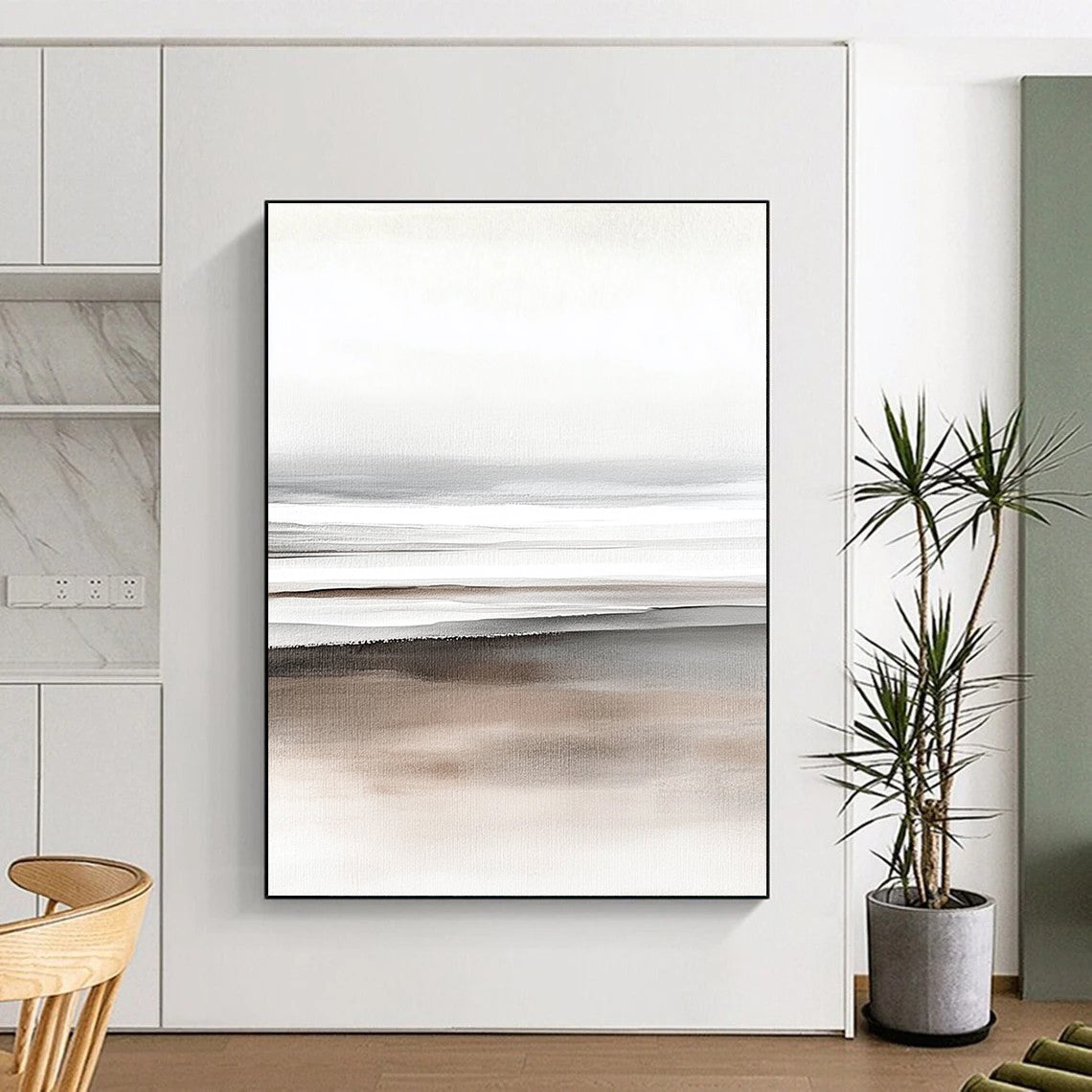 Large abstract watercolor painting depicting beach sand and ocean in soft gray tones and a minimalist design on a neutral beige and white background.STSC499