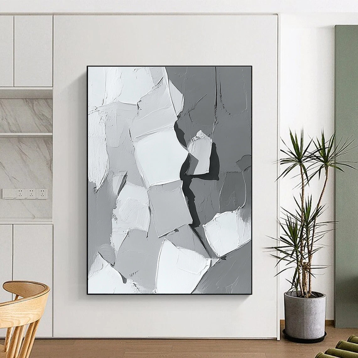 Large abstract painting in gray and white showcasing body parts in armor with bold brush strokes and thick paint application in a striking monochrome palette.STSC479