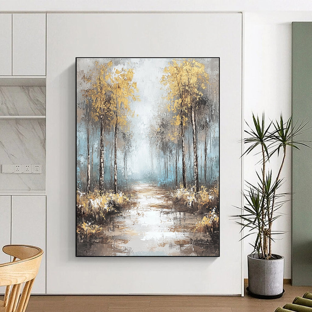 Large abstract painting featuring soft blues and grays with gold leaf accents creating a tranquil misty forest landscape.STSC060