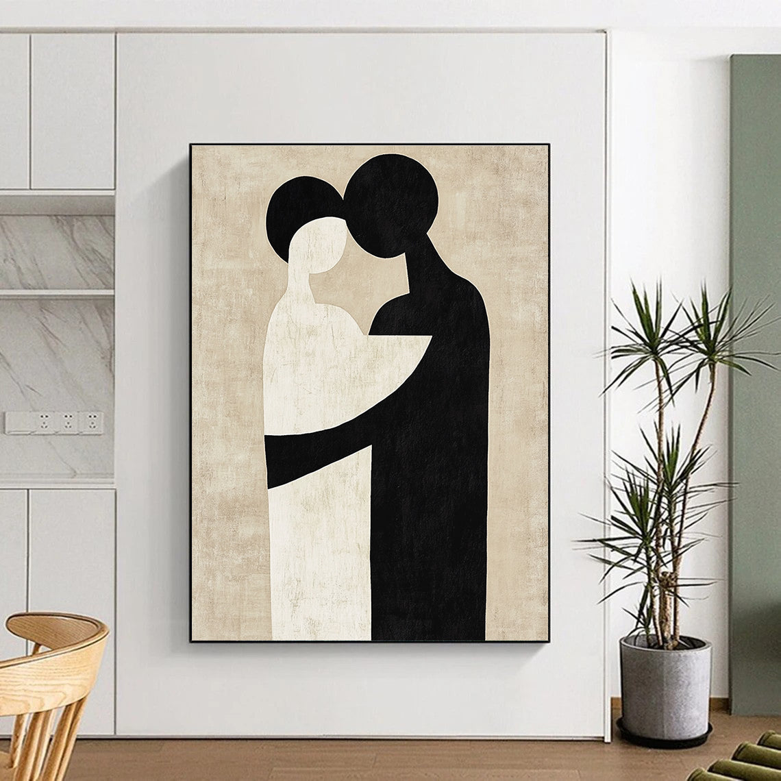 Large abstract artwork featuring black and white shapes that suggest an embrace against a neutral beige background in the style of Paul Klee.STSC473
