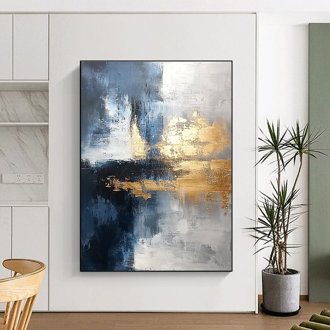 Large abstract painting blending silver and gold with gray blue tones and light brushstrokes featuring exquisite details and a unique composition for a calming atmosphere.STSC376