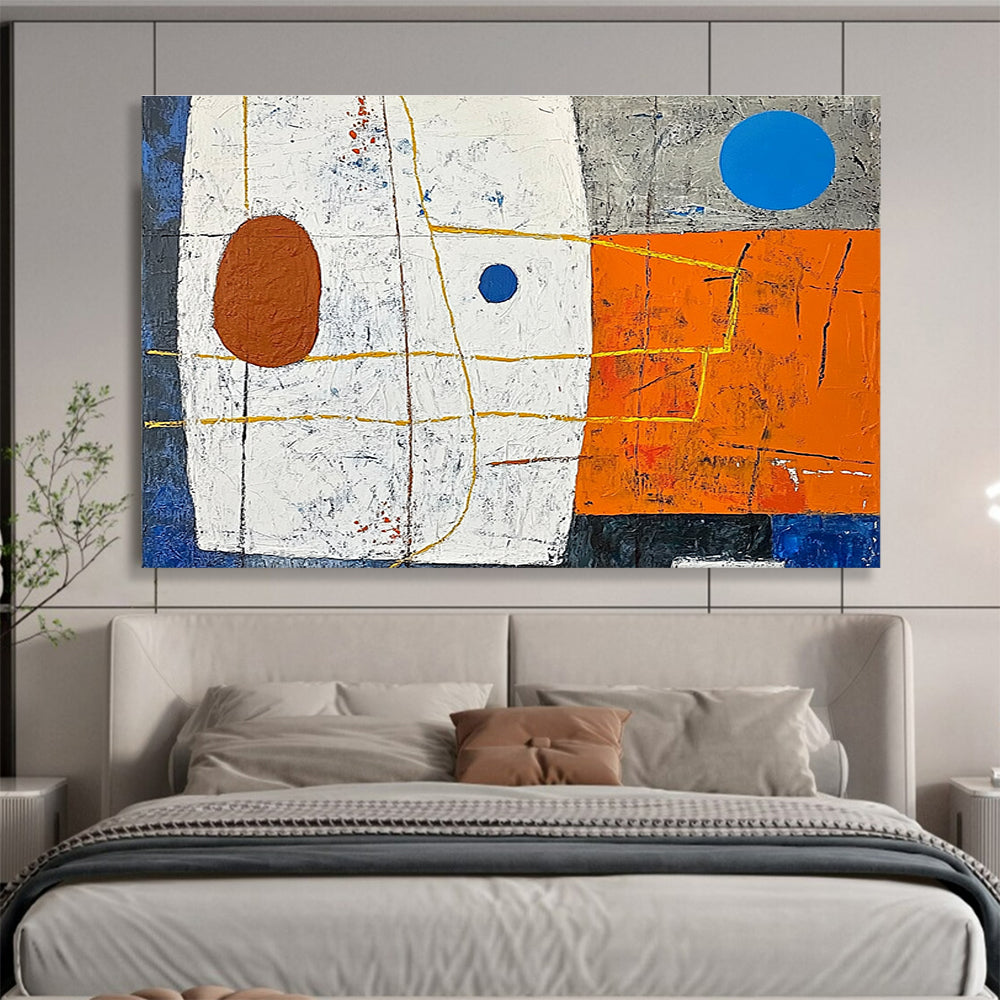 A large abstract painting featuring white squares orange and blue shapes yellow lines a small brown oval and a blue dot on a vibrant orange and dark grey background.SC376