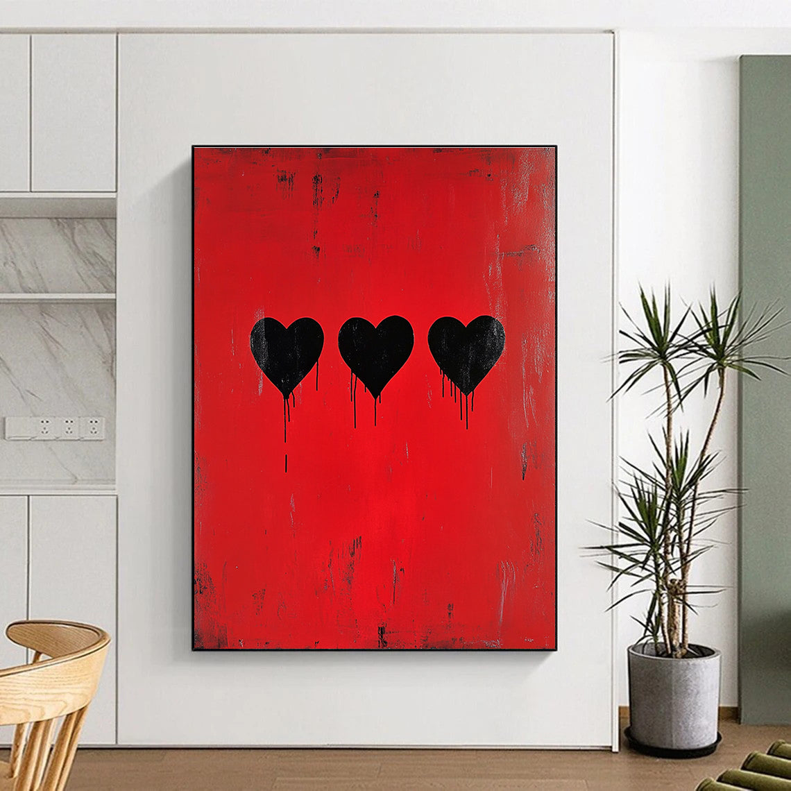 A large abstract painting featuring three black hearts on a red background inspired by Banksy’s minimalistic style.STSC1442