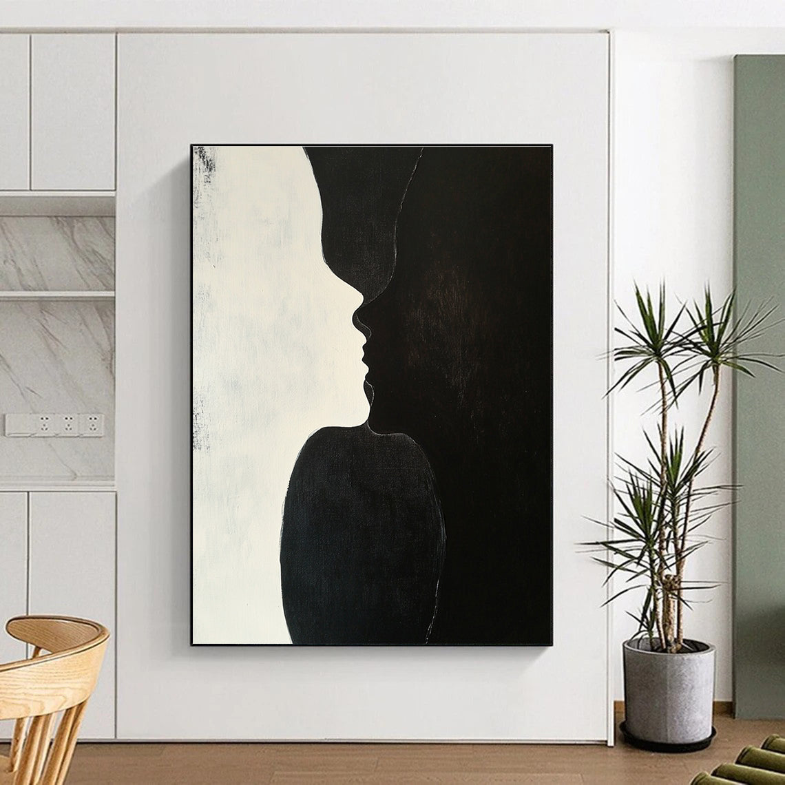 A large abstract painting featuring two figures kissing against a plain black background with subtle shadows highlighting their forms and textures.STSC909