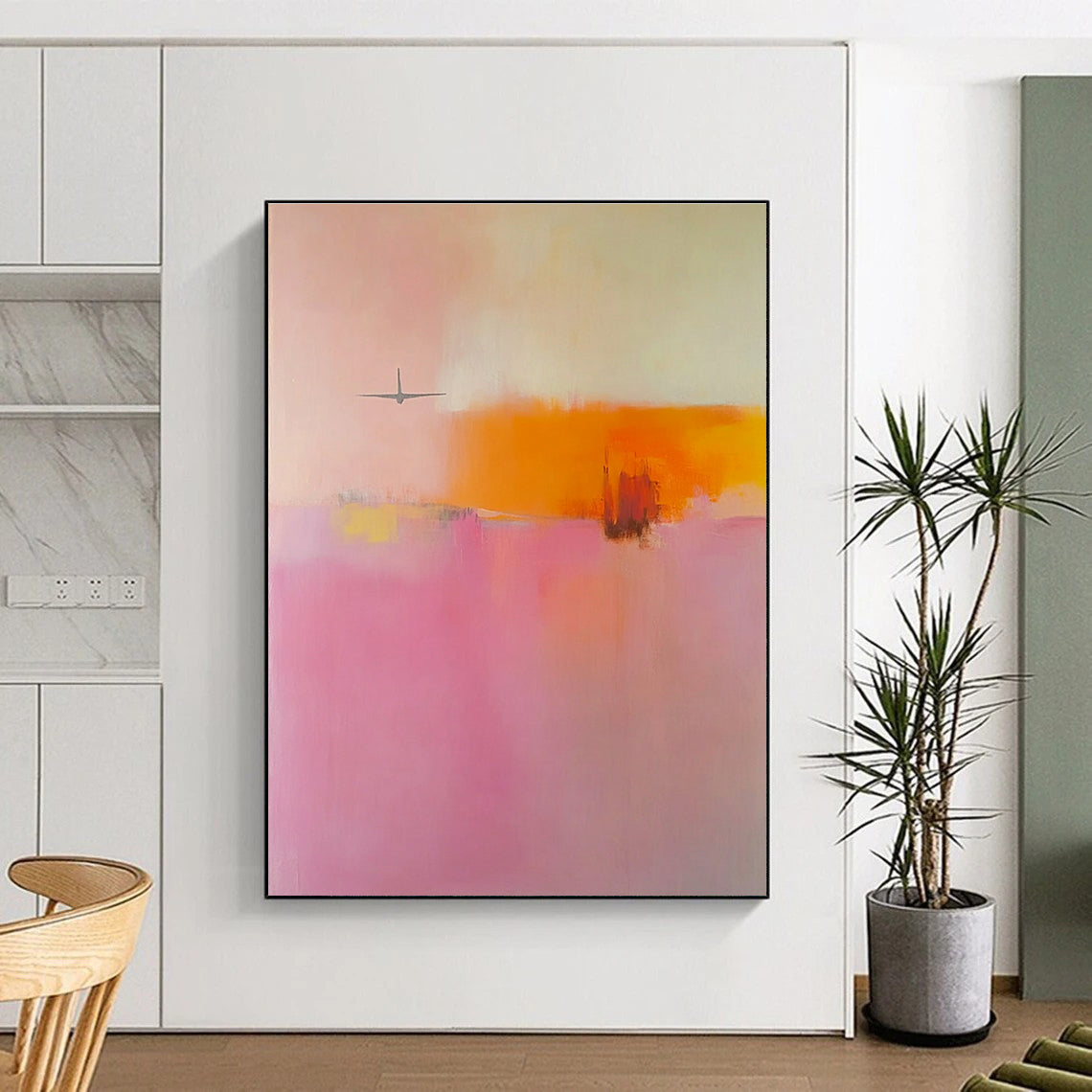 Large abstract painting in soft pink orange and yellow tones featuring blurred edges and an airplane shape in a minimalist style.STSC789