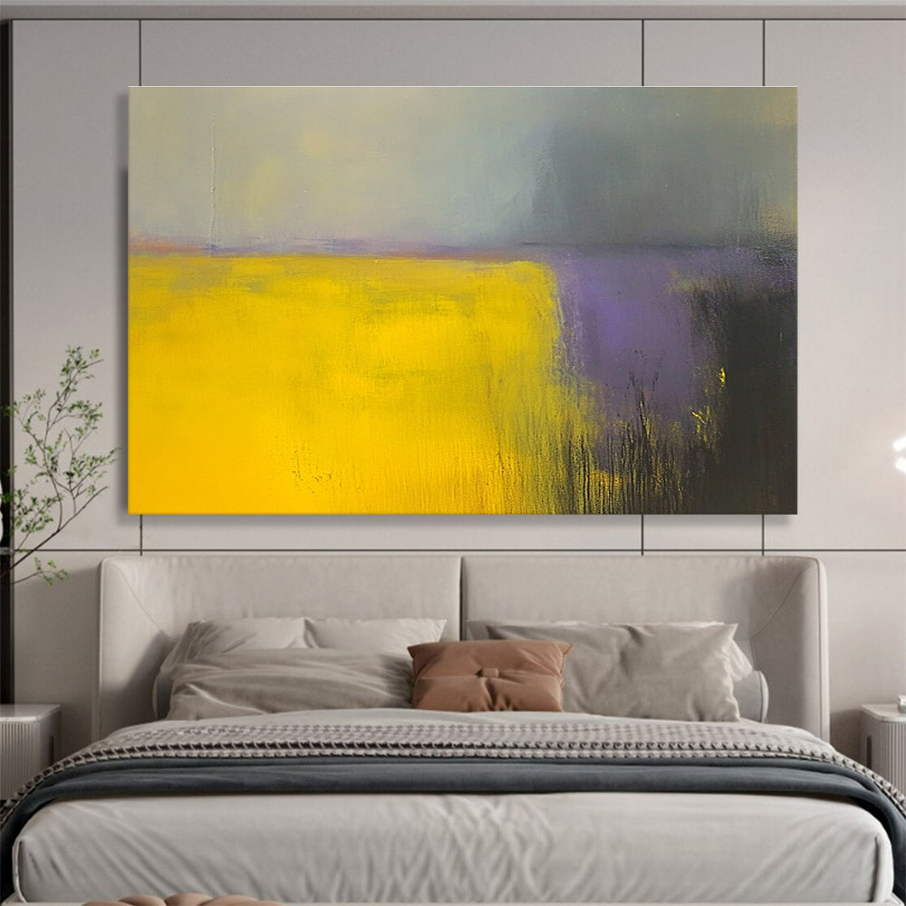 A large abstract painting featuring vibrant yellow and gray fields with subtle purple hues, enhanced by dynamic brushstrokes and a blurred background.SC475