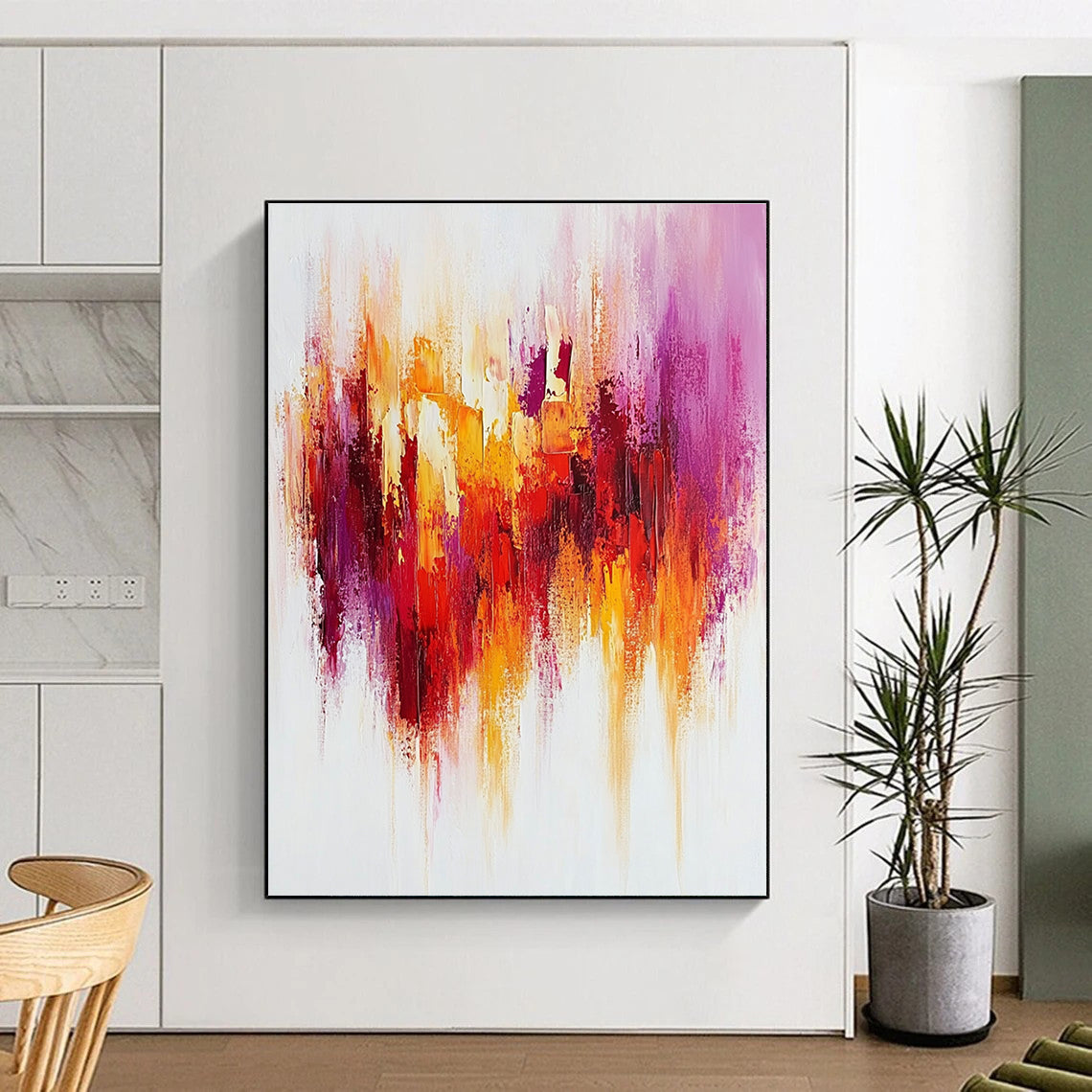 Large abstract painting with textured brush strokes in warm reds and yellows accented by purple on a white background creating a happy uplifting mood.STSC814