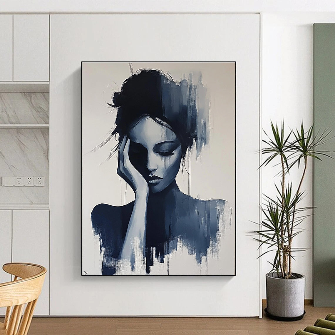 Large abstract painting of a gray woman with her hand on her face and hair up in black and white colors.STSC1378